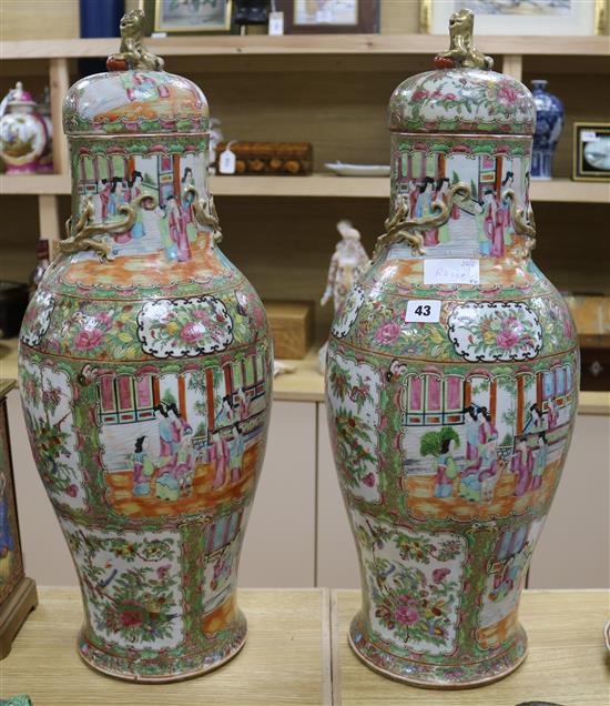 A pair of large 19th century Chinese famille rose vases and cover, 67.5cm high, repaired